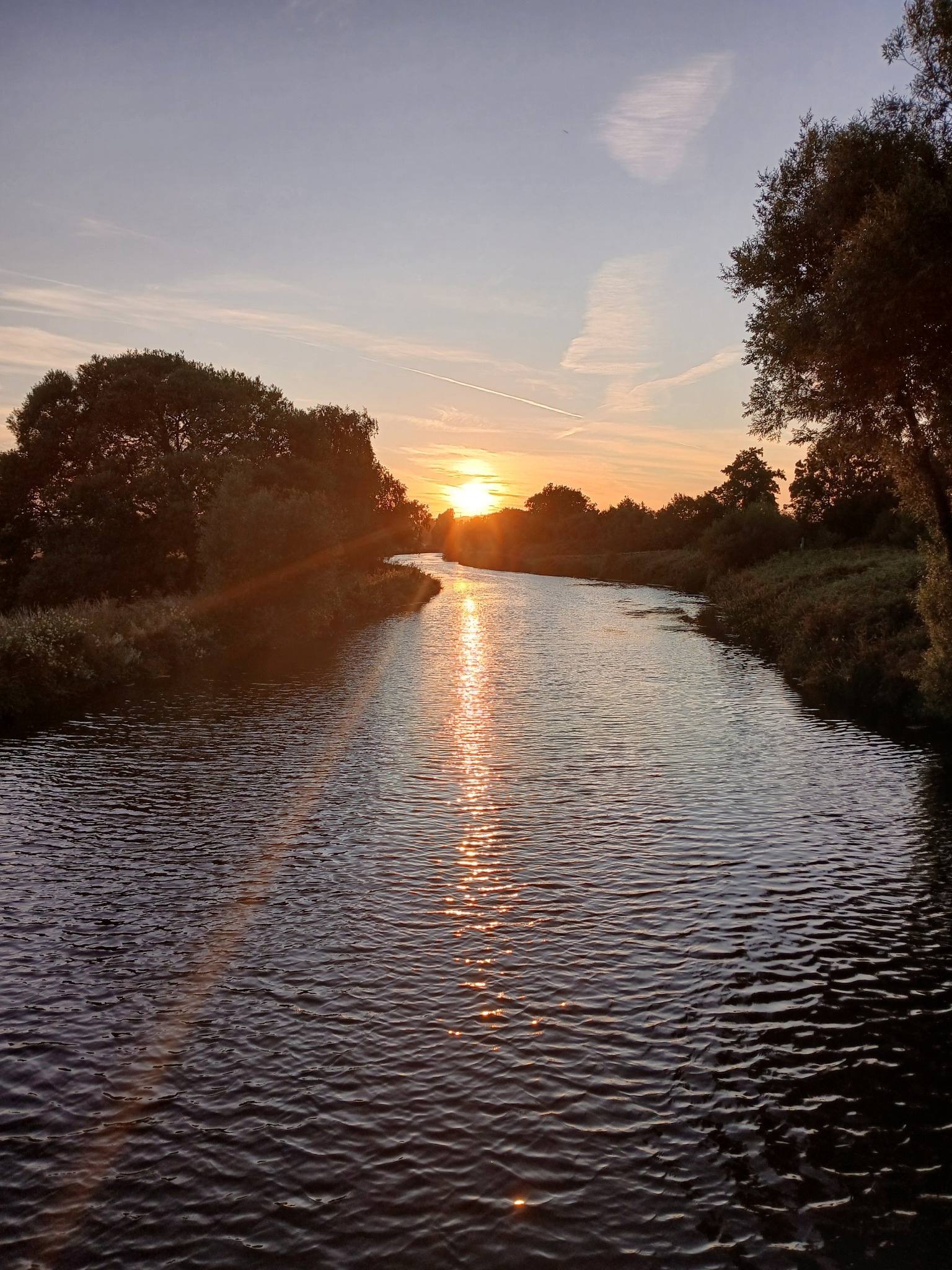 Sunset over a river and trees